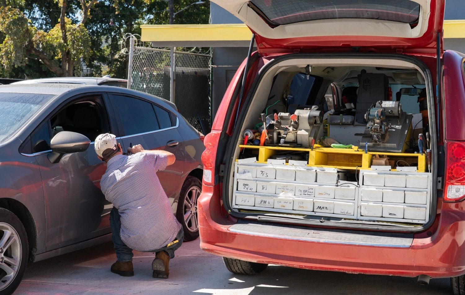 Laptop running key-cutting software beside a key machine: car key programming in Broward County
