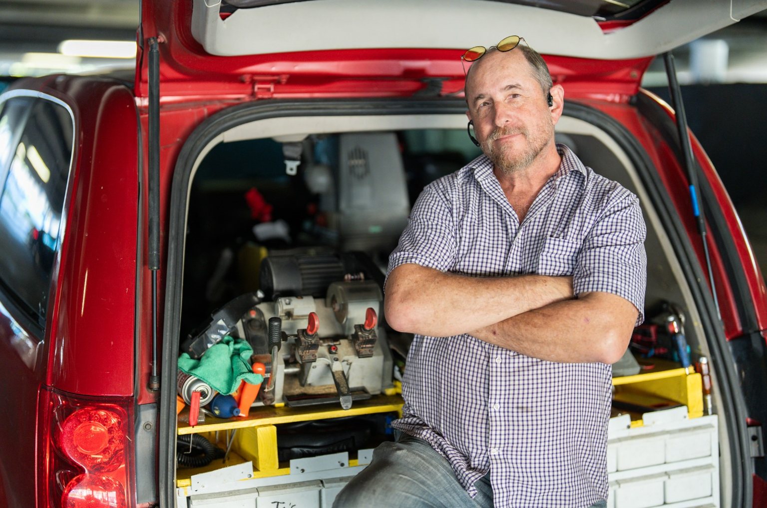 iMakeCarKeys locksmith with arms crossed at his open van workshop in South Florida